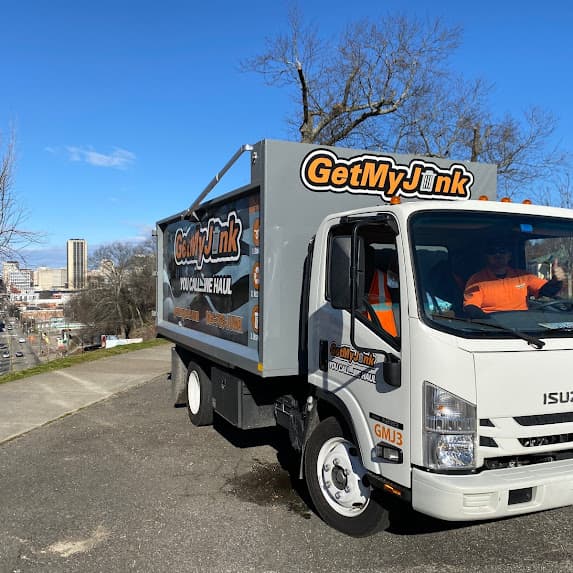 Get My Junk professional junk removal truck with Richmond Virginia skyline background - veteran-owned junk removal service serving Richmond, Henrico, Chesterfield, and surrounding areas